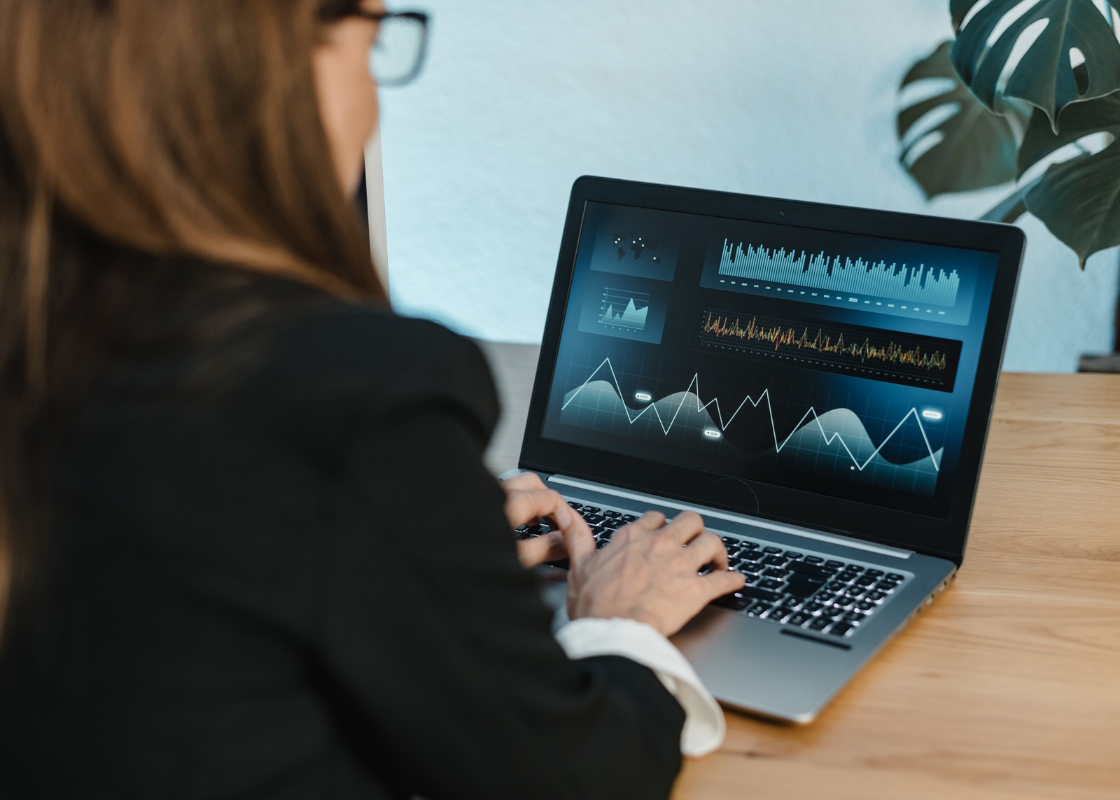 Woman at home looking at business numbers on a laptop